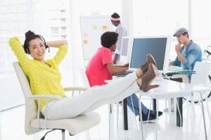 Young creative woman sitting with feet up